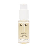 OUAI Hair Oil travel-size bottle closeup showing frizz control and shine.