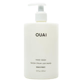 OUAI Hand Wash Dean Street bottle pour highlighting exfoliation and hydration.