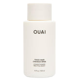 OUAI Thick Hair Conditioner bottle pour showing rich hydration for smooth strands
