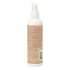 Ouidad Curl Shaper spray application demonstrates easy, even distribution for revitalized curls.