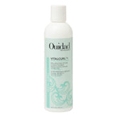Ouidad VitalCurl+ balance bottle demonstrates lightweight hydration for curls.