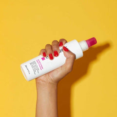 Paul Mitchell treatment being sprayed for targeted hair repair.
