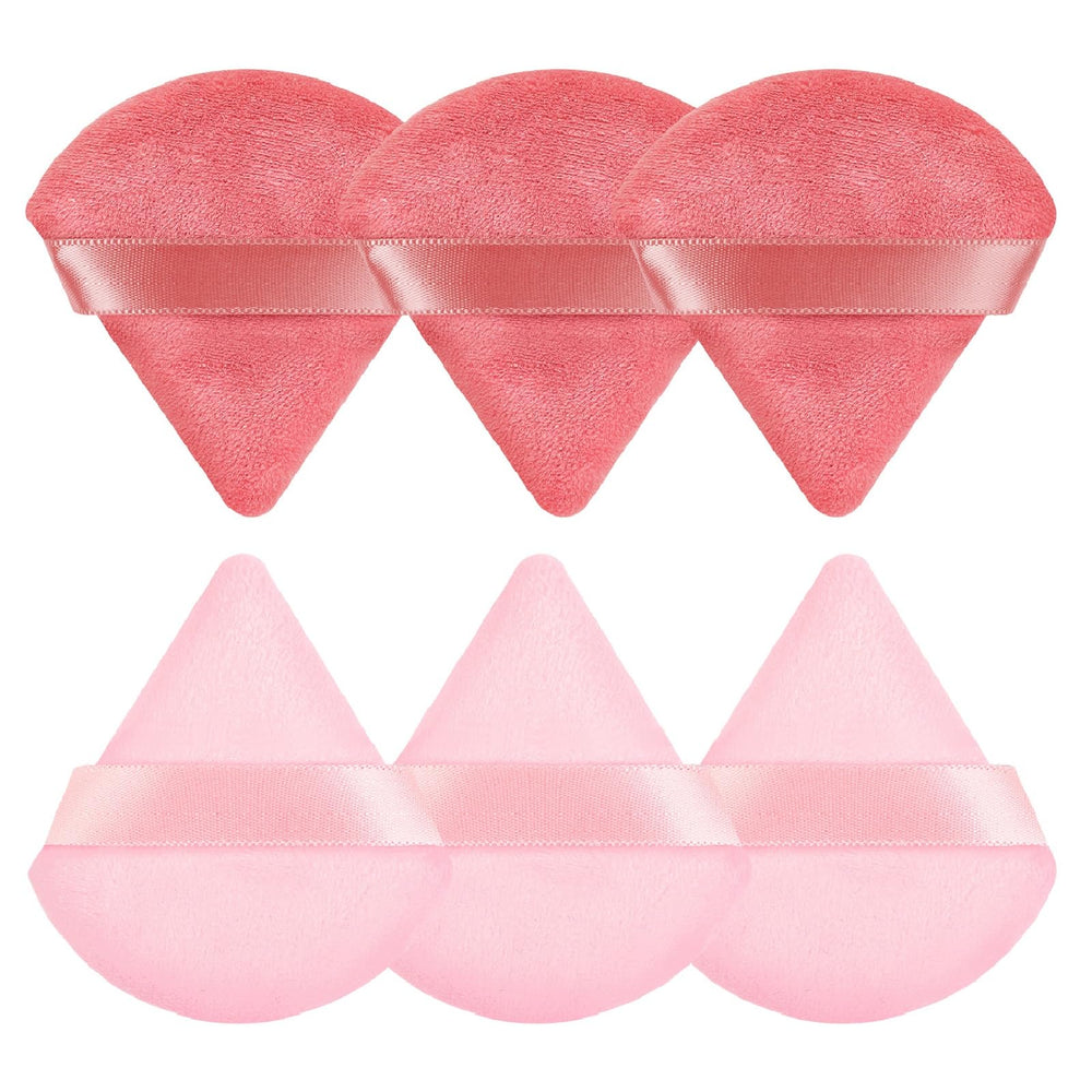 Pimoys triangle pink powder puff close-up for precise cheek application.