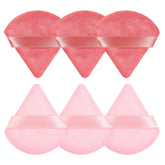 Pimoys triangle pink powder puff close-up for precise cheek application.
