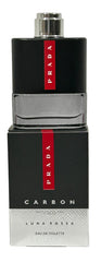 Cap close-up on Prada Luna Rossa Carbon mini edt 9ml highlighting compact luxury