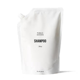 Public Goods Shampoo bottle with pour spout for easy, mess-free use.
