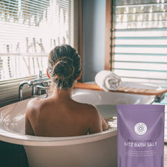 Pure Body Naturals Sitz Bath Salt in a bath-scene setup for a calming ritual.