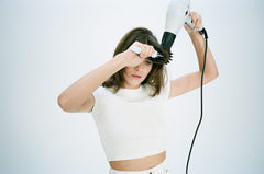 Mood Swing spray on styled hair ready for a sleek blowout.