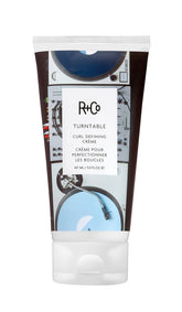 R+Co TURNTABLE bottle close-up showcasing lightweight curl-defining formula.