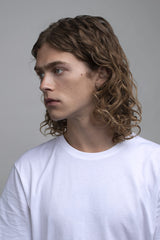 R+Co Velvet Curtain hands applying balm to create texture.