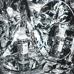 R+Co Foil Frizz + Static spray in use on hair during application.