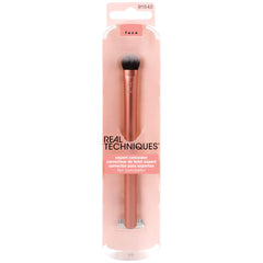 Real Techniques Expert Concealer Brush targets the eye area for smooth blending.