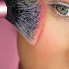 Real Techniques Mini Multitask Brush in hand for on-the-go touch-ups