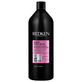 Redken Acidic Color Gloss shampoo bottle highlights shine protection for color-treated hair.
