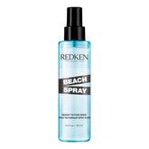 Redken Beach Spray bottle close-up showing sea-salt-free formula for texture.
