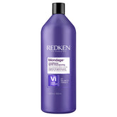 Redken Blondage bottle pour shows color-depositing action to neutralize brass.