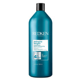 Redken Extreme Length conditioner bottle highlights biotin and castor oil for stronger, longer hair.