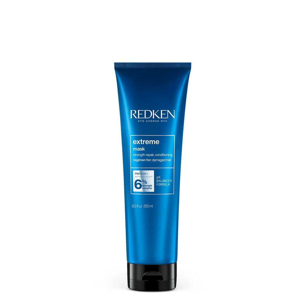 Redken Extreme Mask bottle close-up, ready to fortify damaged hair.