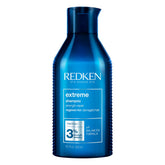 Redken Extreme Shampoo bottle pour showing strength for damaged hair