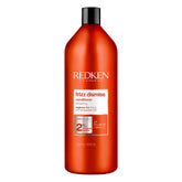 Redken Frizz Dismiss conditioner bottle delivering smooth frizz control.
