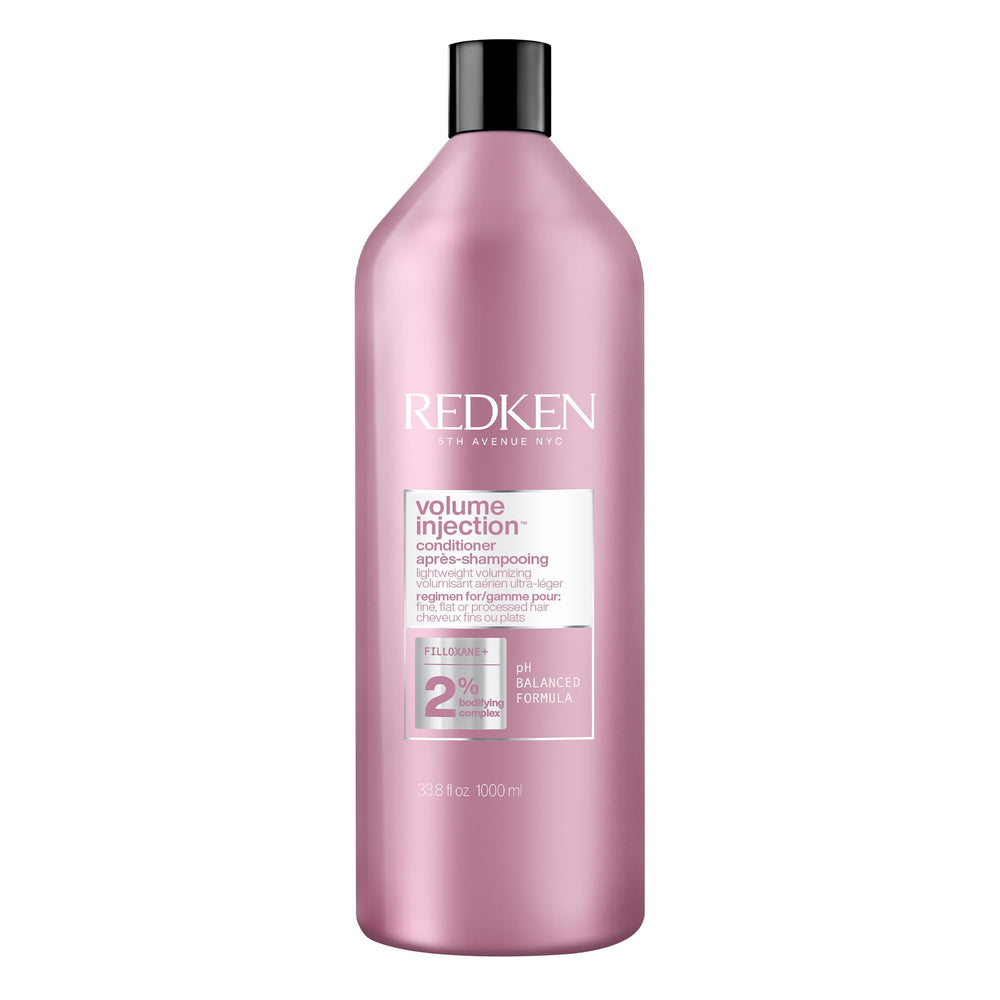 Redken Volume Injection Conditioner bottle pour demonstrates root lift potential