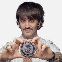 REUZEL Concrete Matte Pomade hands applying for easy, mess-free styling.
