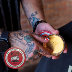 REUZEL Red Pomade shine close-up emphasizes a glossy finish.