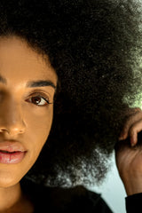 REVERIE anti-frizz leave-in close-up on bottle emphasizes lightweight moisture