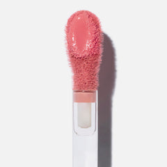 Swatch of Saie Dew Liquid Blush in Sweetie showing buildable color on cheek.