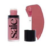 Saie Dew Liquid Blush bottle-pour demonstrates precise application and radiant glow.