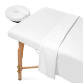 Saloniture flat sheet on a massage table offering breathable comfort for clients.