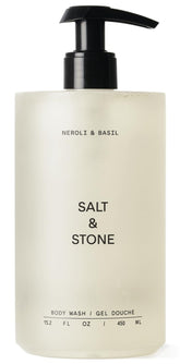 Salt & Stone Neroli & Basil body wash bottle pouring for a rich, aromatic cleanse.