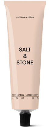 Salt & Stone body lotion bottle with saffron-cedar scent and instant hydration.