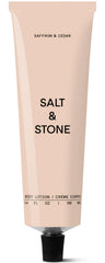Salt & Stone body lotion bottle with saffron-cedar scent and instant hydration.