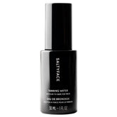 SaltyFace Tanning Water bottle closeup highlighting a clean, water-light formula for daily use