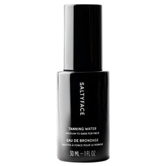 SaltyFace Tanning Water bottle closeup highlighting a clean, water-light formula for daily use