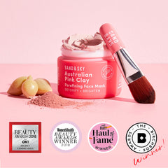 Sand and Sky pink clay mask being applied with brush for even coverage.