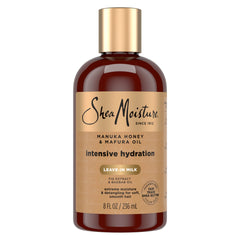 Botella SheaMoisture leche hidratante para cabello con miel de Manuka y aceite Mafura, hidratación suave.