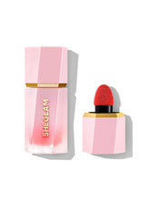 SHEGLAM Color Bloom liquid blush Candy Apple swatch on skin showing natural flush.