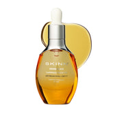 SKINN anti-aging luminous face oil bottle showing premium packaging and glow