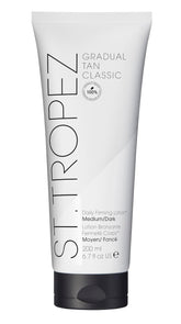 St. Tropez Gradual Tan Firming Lotion bottle shows buildable glow on skin.