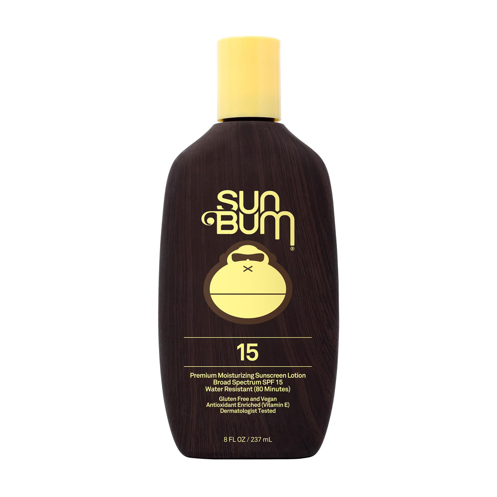 Sun Bum Original SPF 15 lotion bottle on a sunny beach, protecting skin daily