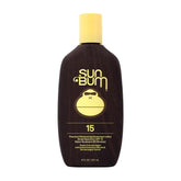Sun Bum Original SPF 15 lotion bottle on a sunny beach, protecting skin daily