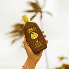 Applying Sun Bum Original SPF 30 sunscreen lotion to skin for protection.