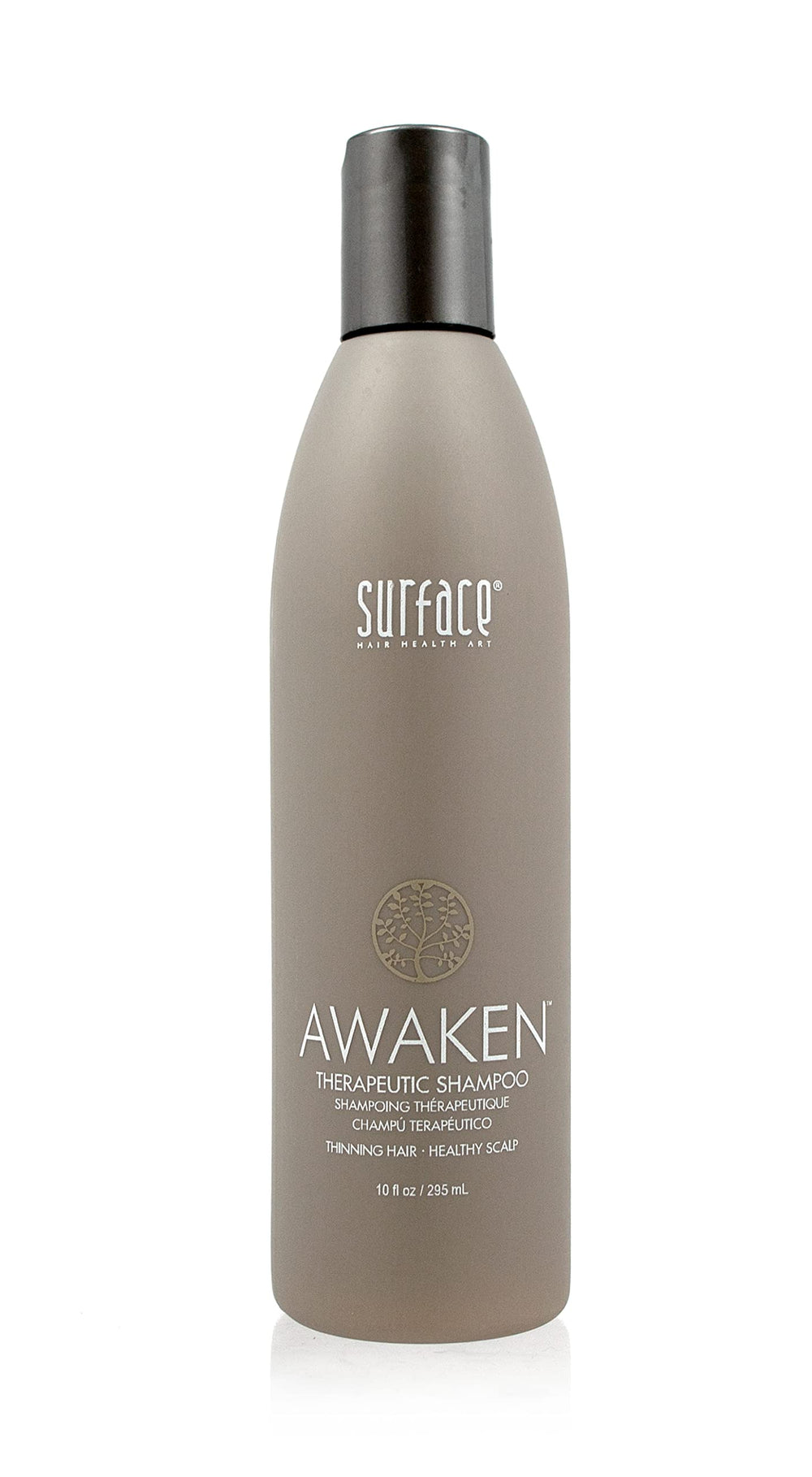Surface Awaken Therapeutic Shampoo bottle shows nourishing oils for scalp health.