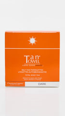 TanTowel Dark towelettes applying to skin for quick, mess-free self-tanning results.