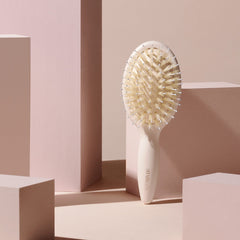 The Hair Edit brush smoothing dry hair for a sleek, finished look