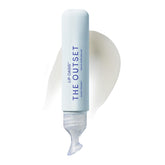 The Outset Lip Oasis lip balm tube open, ready to hydrate dry lips with a glassy finish.