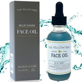 The Yellow Bird Balancing Blue Tansy face oil bottle close-up for radiant, balanced skin support.