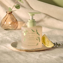 Close view of Thymes Nourishing Hand Wash bottle pour demonstrating dispensing